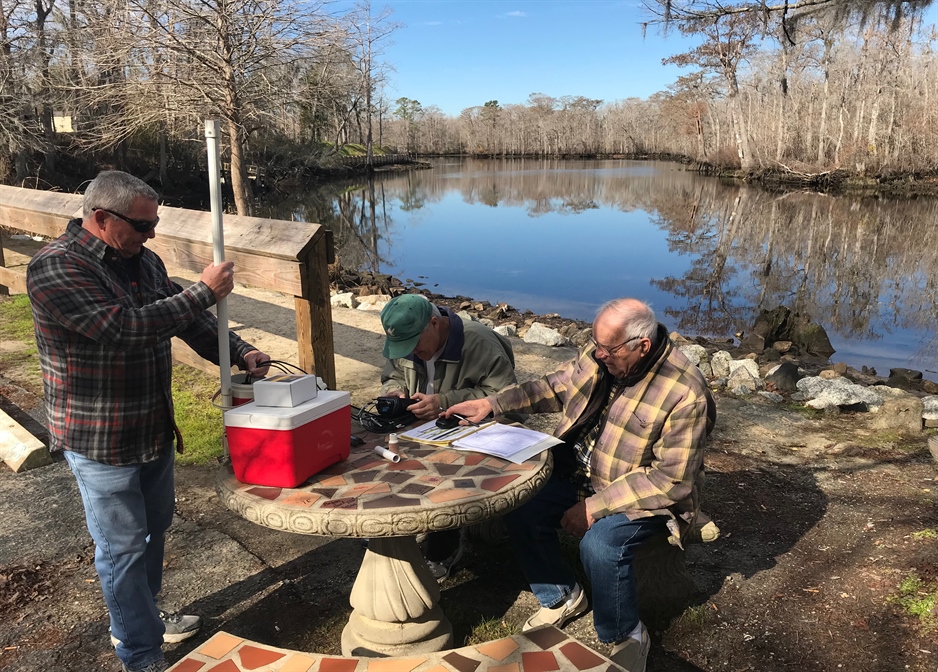 A photo of volunteers sampling by the river