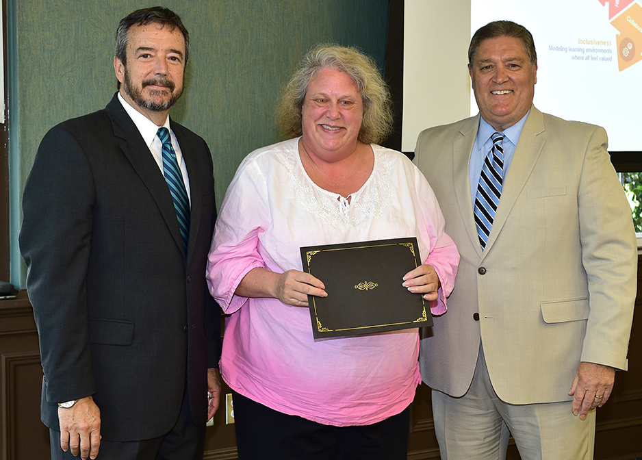 Suzanne Horn receives her certificate from Dr. DeCenzo and Dr. Byington