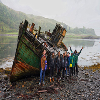 Group of CCU students in front of old boat in Oban Scotland
