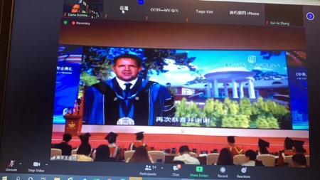Benson addressing an audience in China