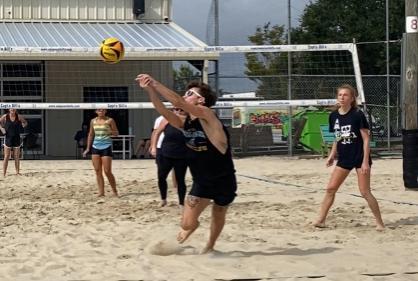 photo of students playing beach volleyball