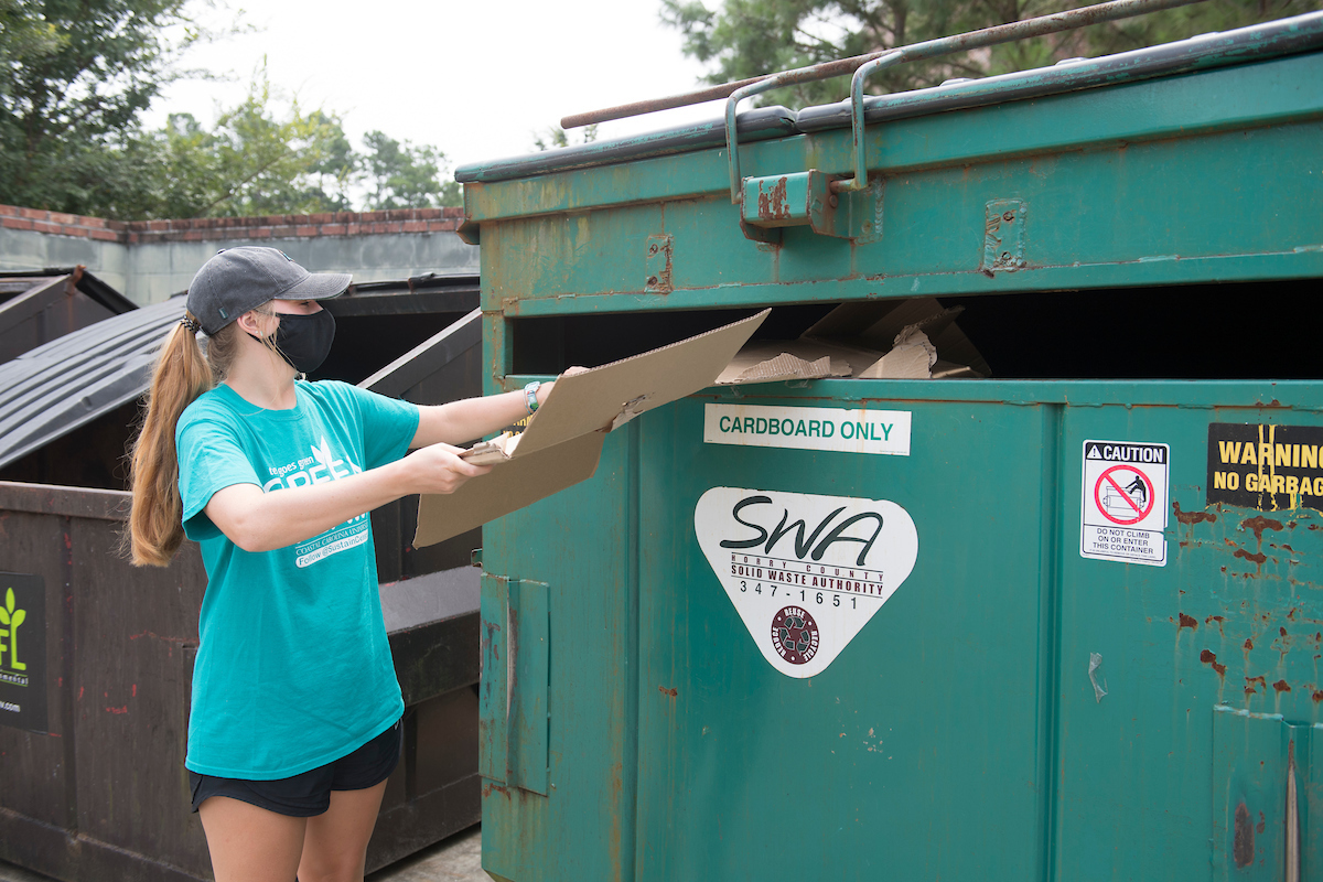 A student recycling cardboard