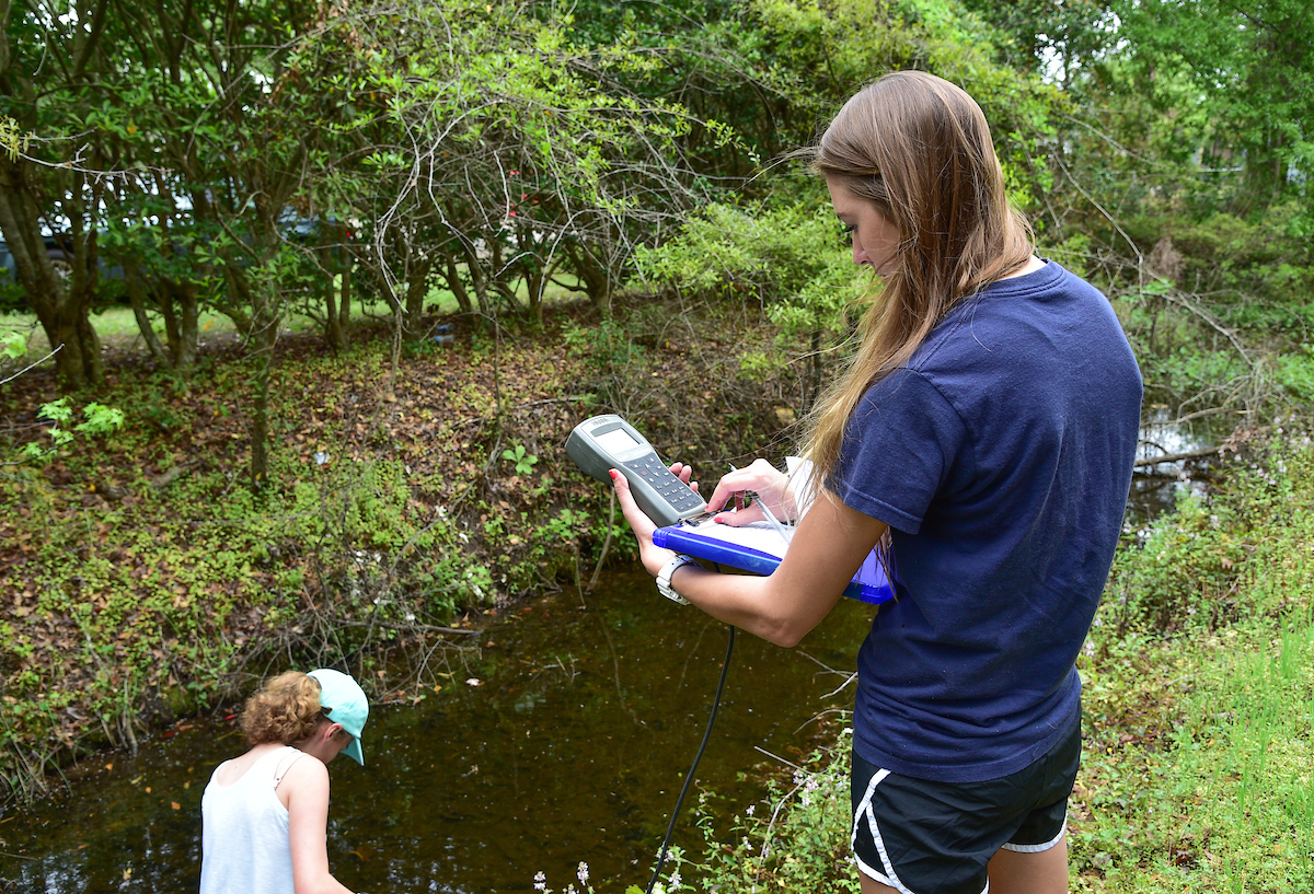 A student monitoring water quality