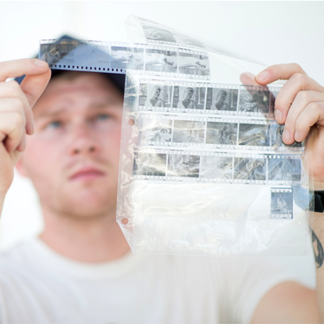 Photography Student with film negatives in the photography studio.