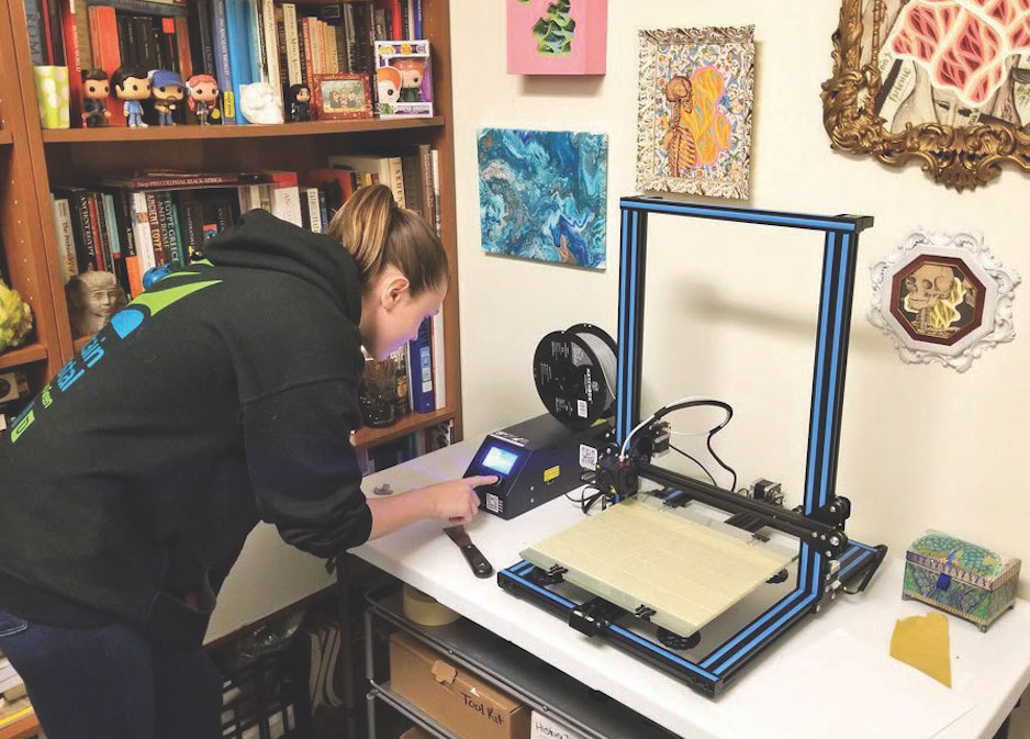 A student creates a 3D print of a lab.