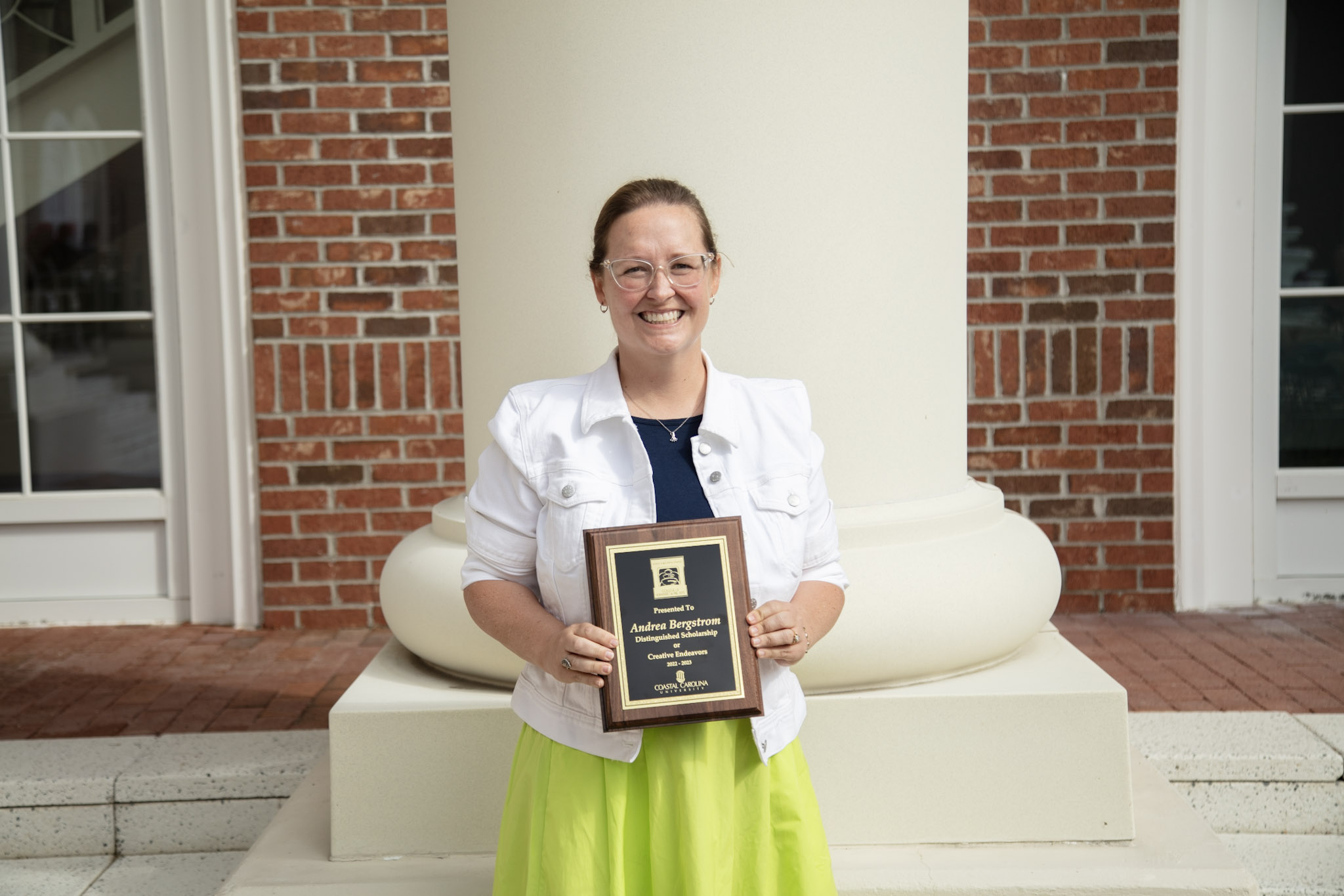 Image of Dr. Andrea Bergstrom holding an award