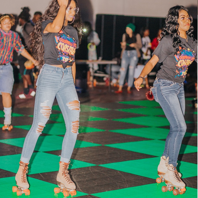 Two student roller skating at a CAB Homecoming Event