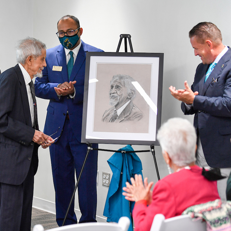 Subhash Saxena, Ph.D., was given a portrait of himself during the dedication ceremony on April 19.