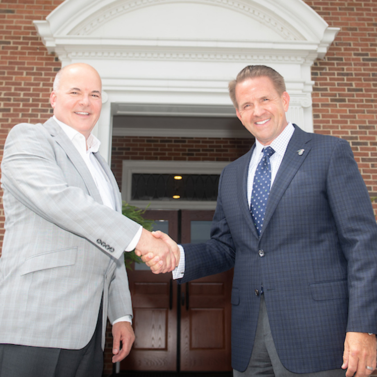 Bret Barr (left), CMC president/CEO, and Michael T. Benson, CCU president, on the steps of the University's Singleton Building after signing the historic gift agreement.