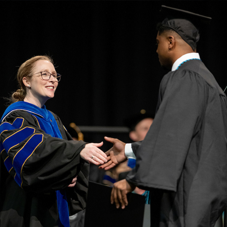 Dean Erika Small congratulates a new Wall College graduate.