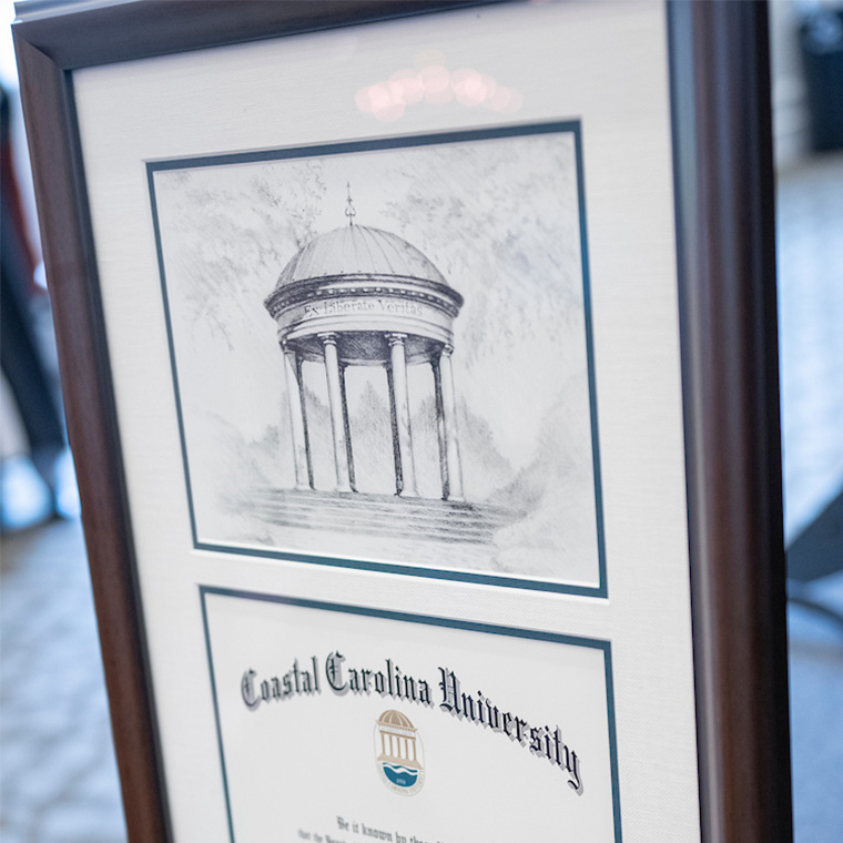 In recognition of graduating, the Coastal Carolina University College of Graduate and Continuing Studies gave each doctoral candidate a drawing of the Atheneum, created by CCU alumnus Joshua Knight ’1